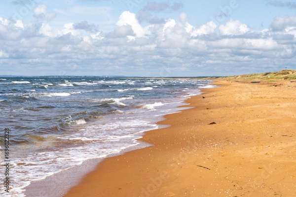 Fototapeta The stunning beach view in Southern Sweden and charming coastal town under a beautiful cloudy sky, Bastad, Sweden