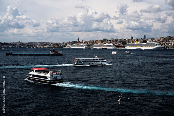 Fototapeta Costa Fortuna cruise ship and other little big ships on the Bosphorus of Istanbul. Ferries and passenger boats are visible cruising the Bosphorus, with large cruise ships in the background. Galata Tow