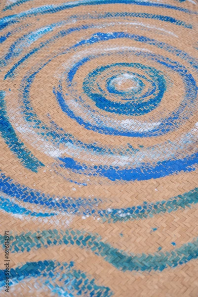 Fototapeta Swirling blue patterns on woven surface