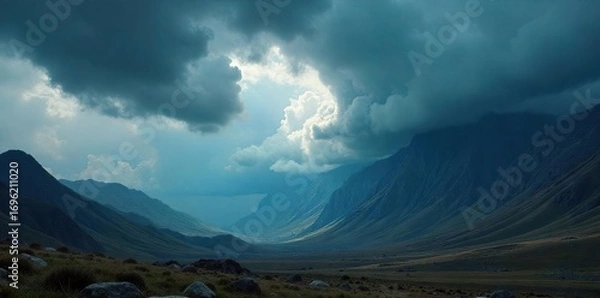 Obraz Dramatic, dark stormy cloudscape over a vast, mountainous landscape Perfect for illustrating power, nature, and epic scale Ideal for fantasy, adventure, or environmental themes , panoramic, wide shot