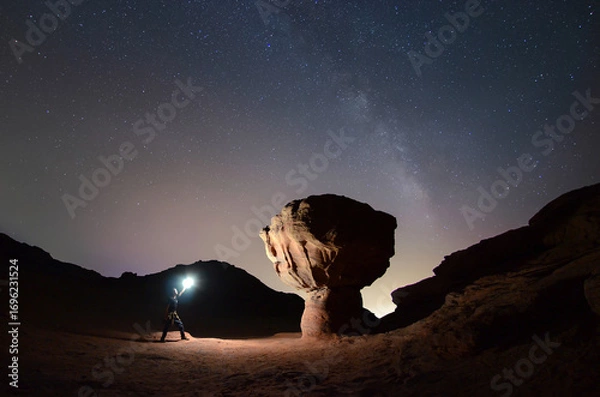 Obraz night photo of a man with light near Mushroom Rock at Timna National Park with the Milky Way