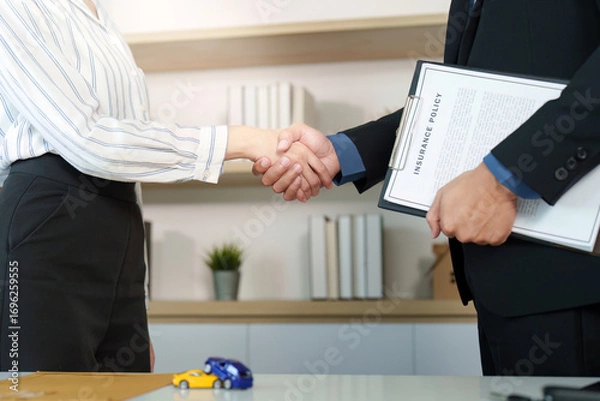 Fototapeta Insurance Agreement. Client and agent shaking hands after signing policy.