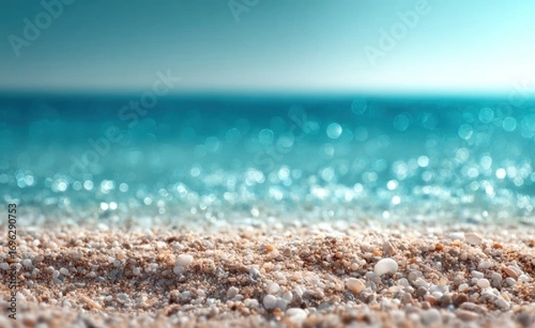 Fototapeta Coastal serenity soft sand in focus, transitioning to a sparkling azure sea under a bright sky, creating a peaceful, blurred seascape