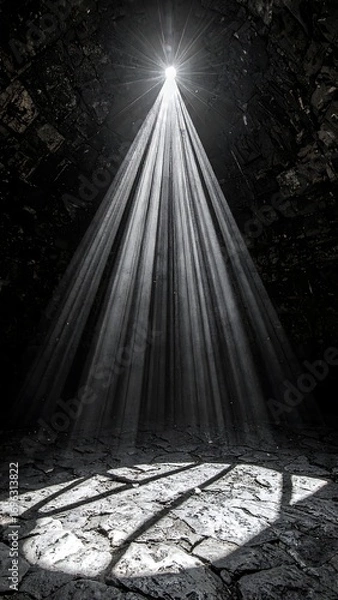 Fototapeta Dramatic light rays pierce a dark, stone-paved interior, illuminating a circular area below.