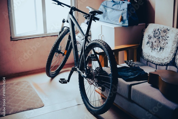 Fototapeta A retro styled photo of a bicycle in a small living room