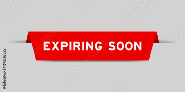 Fototapeta Red color inserted label with word expiring soon on gray background