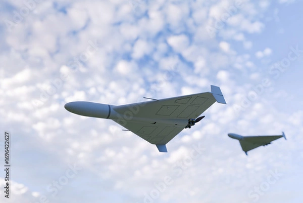 Fototapeta Two military drones flying in the sky with scattered clouds, showcasing modern unmanned aerial vehicle technology used for surveillance, reconnaissance, and defense operations. Military drone flies