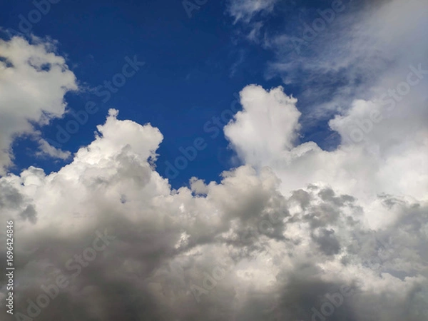 Fototapeta Dynamic Cloud Layers in Deep Blue Sky