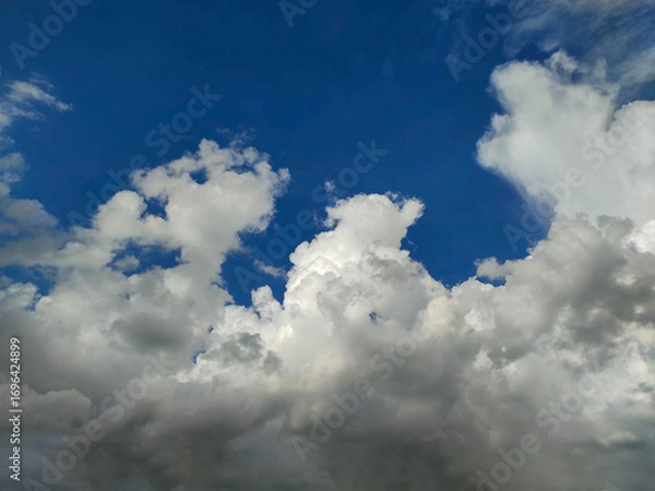 Fototapeta Towering Cumulus Clouds in Deep Blue Sky