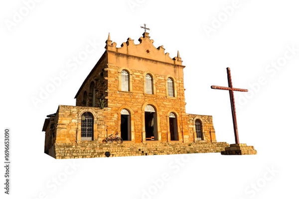 Fototapeta Facade of an old stone church with colonial architecture, located in Brazil. The building is in the Baroque style. Golden sunlight, a tranquil atmosphere, faith, and historical richness.