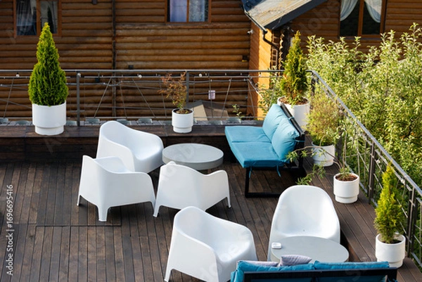 Fototapeta Terrace for relaxation with soft sofas and chairs.