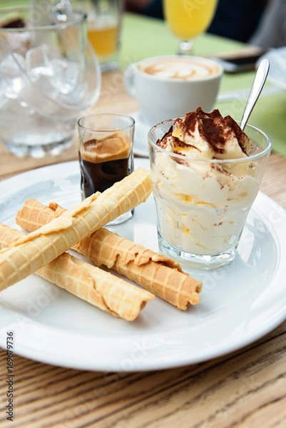 Obraz Italian dessert Tiramisu served in original manner. Tiramisu served in glass with coffee and biscuits.