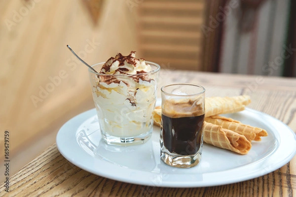 Obraz Italian dessert Tiramisu served in original manner. Tiramisu served in glass with coffee and biscuits.