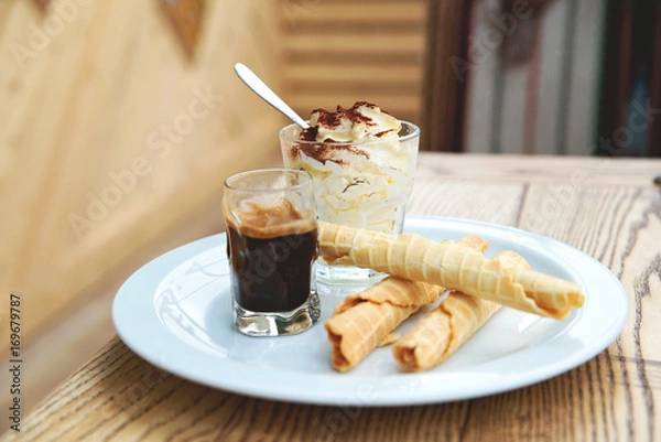 Obraz Italian dessert Tiramisu served in original manner. Tiramisu served in glass with coffee and biscuits.