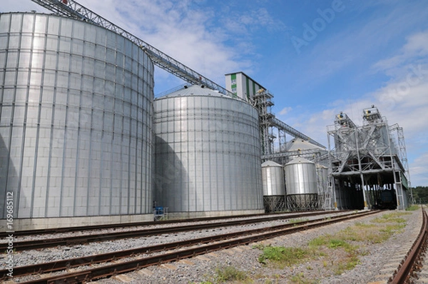 Obraz Agricultural Silos.  metal grain facility with silos.