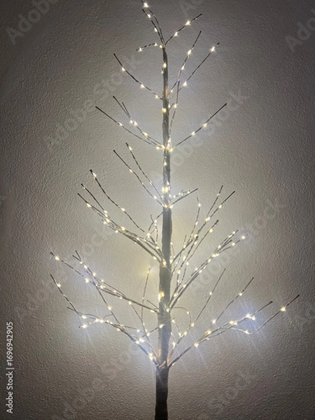 Fototapeta Glowing decorative tree with lights on branches, copy space, New Year concept