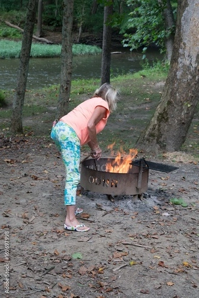 Fototapeta Stoking the fire