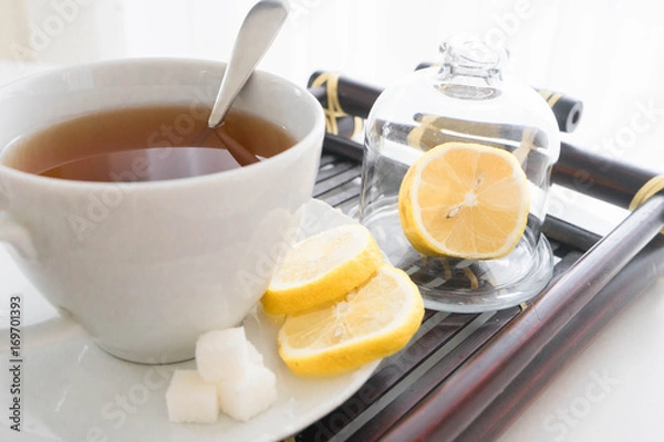 Fototapeta hot tea with lemon and sugar