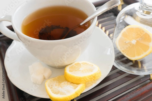 Fototapeta hot tea with lemon and sugar