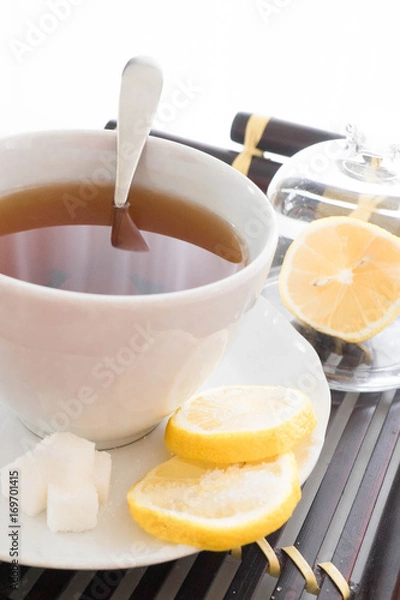 Fototapeta hot tea with lemon and sugar