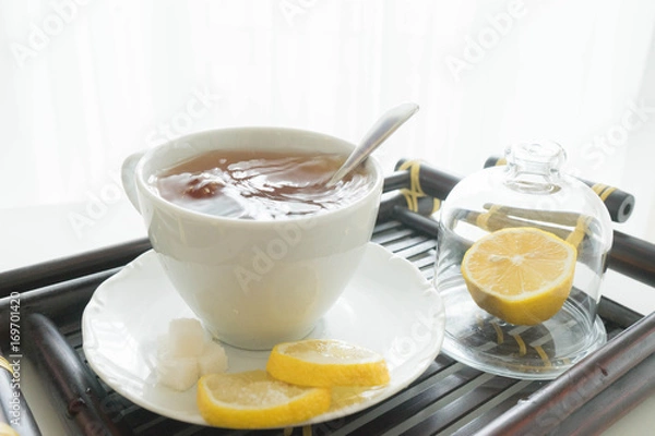 Fototapeta hot tea with lemon and sugar