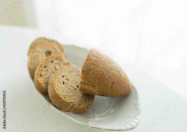 Fototapeta Black cereal chopped on a plate of bread