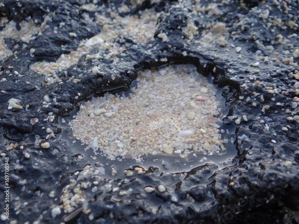 Fototapeta heart shaped stone with sand inside