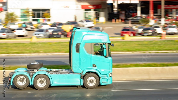 Fototapeta Bold and Bare: Turquoise Truck Cab on the Move