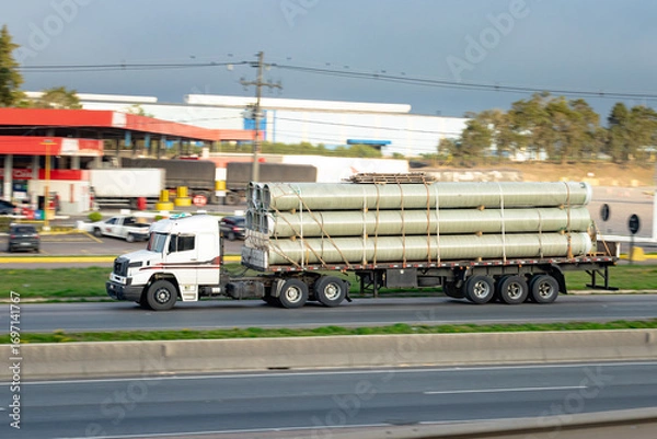 Fototapeta Heavy Haul: Pipes in Transit on Open Highway