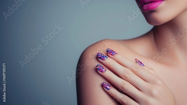 Fototapeta A woman's hand with beautifully manicured nails featuring a bold, colorful polka dot design. The hand is gently touching her shoulder.