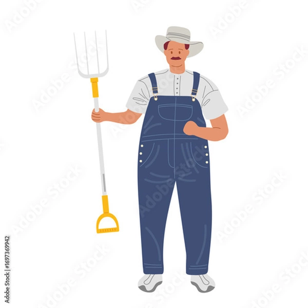 Fototapeta Farmer holding a pitchfork in overalls with a straw hat on a sunny day