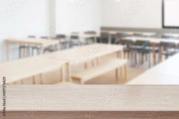 Fototapeta Wooden table with blurred cafeteria or dining hall background
