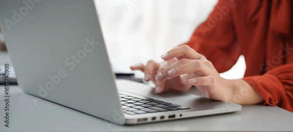 Fototapeta Freelancer working from home typing on laptop keyboard
