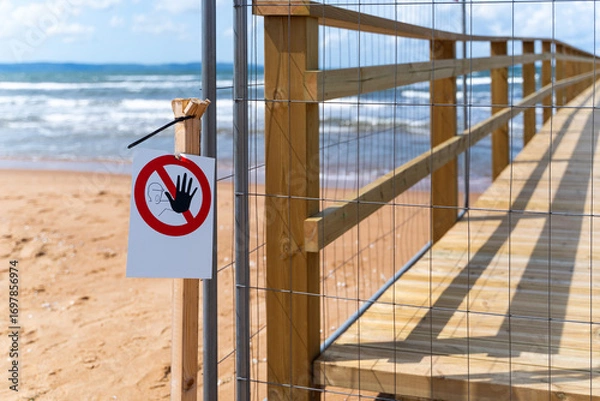 Fototapeta A Beach Pier is currently Under Construction, and Various Water Containers are Present Nearby