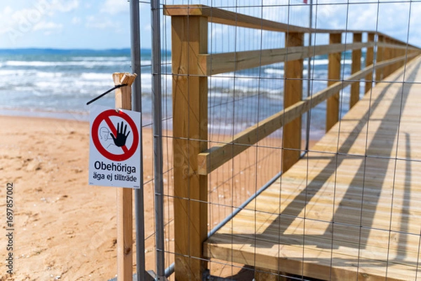 Fototapeta A Beach Pier is currently Under Construction, and Various Water Containers are Present Nearby