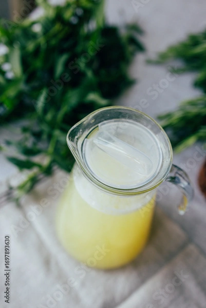 Fototapeta Homemade lemonade with mint, lemon and lime in a glass pitcher on the table. Refreshing drink, nutrition, healthy lifestyle