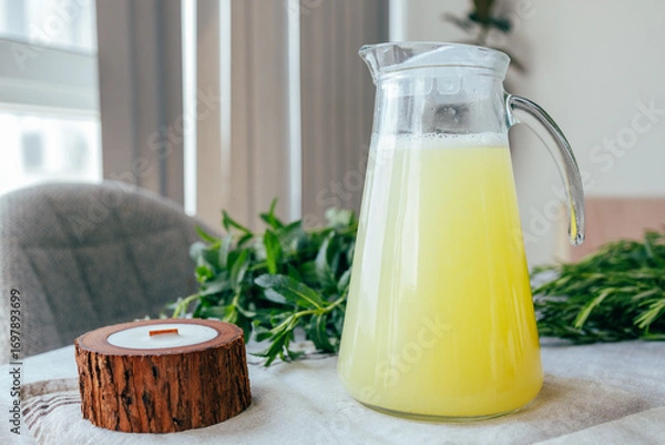 Fototapeta Homemade lemonade with mint, lemon and lime in a glass pitcher on the table. Refreshing drink, nutrition, healthy lifestyle