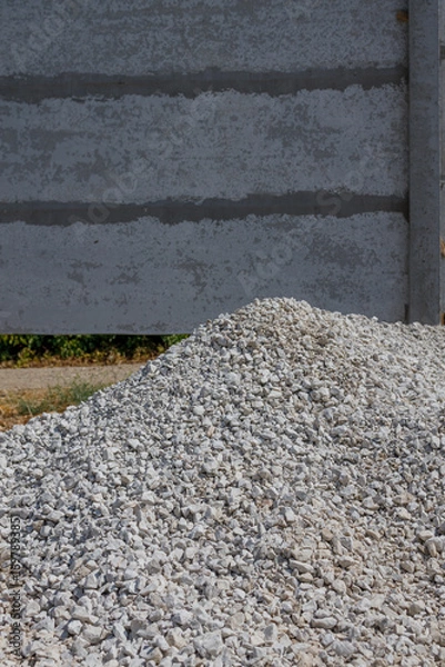 Fototapeta A pile of crushed stone, gravel for construction work, used for building foundations, road works and repairs. Construction and architectural industry	