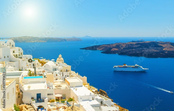 Fototapeta Beautiful panoramic view from touristic Fira town to caldera and volcano at summer sunny day. Santorini(Thira) island.