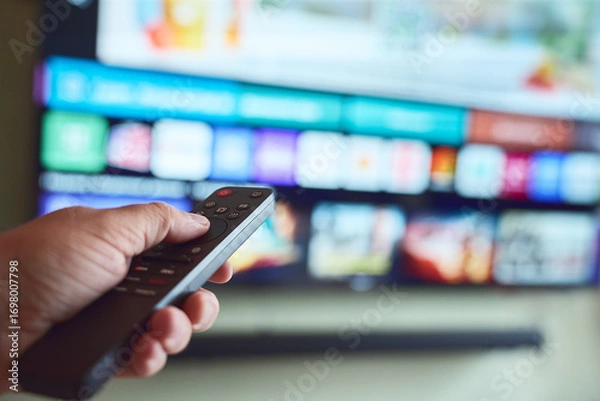 Obraz Watching television with remote control