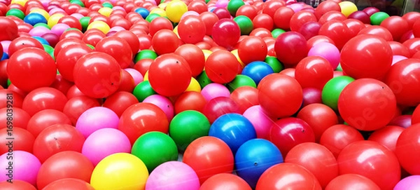 Fototapeta A top view image of a vibrant and colorful background of plastic balls in various colors.
