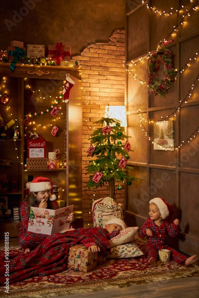 Fototapeta Children reading a Christmas story