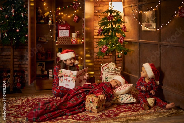Fototapeta Children reading a Christmas story
