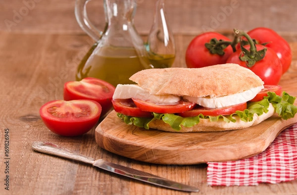 Fototapeta Puccia bread with mozzarella and tomato. 