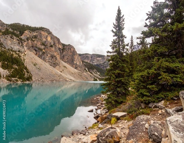 Fototapeta Tranquil alpine lake reflected in the clouds