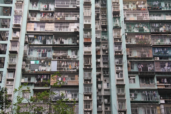 Fototapeta Chaotic dense urban apartment building facade crowded residential housing complex