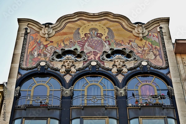 Fototapeta beautiful gold mosaic decorated residential building elevation detail with balconies and large arched windows and stone architectural relief in Budapest, Hungary. travel and tourism concept