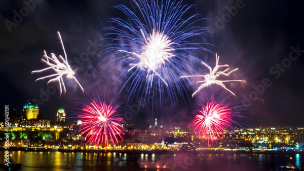 Obraz Colorful fireworks over the Saint-Lawrence River with a part of Quebec city in the background. Quebec, Canada.