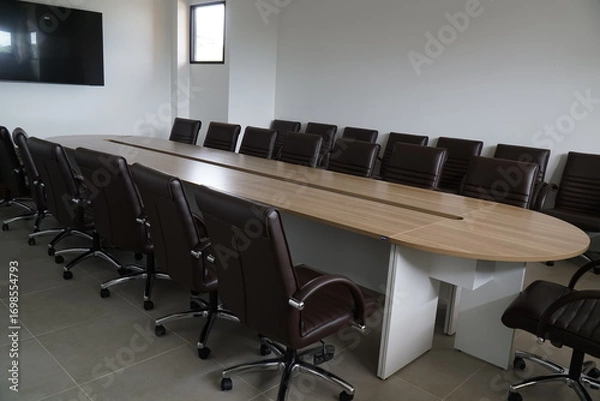 Fototapeta Large conference table with many chairs around it