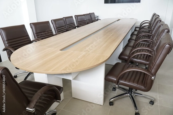 Fototapeta Large wooden table with a long row of brown chairs around it